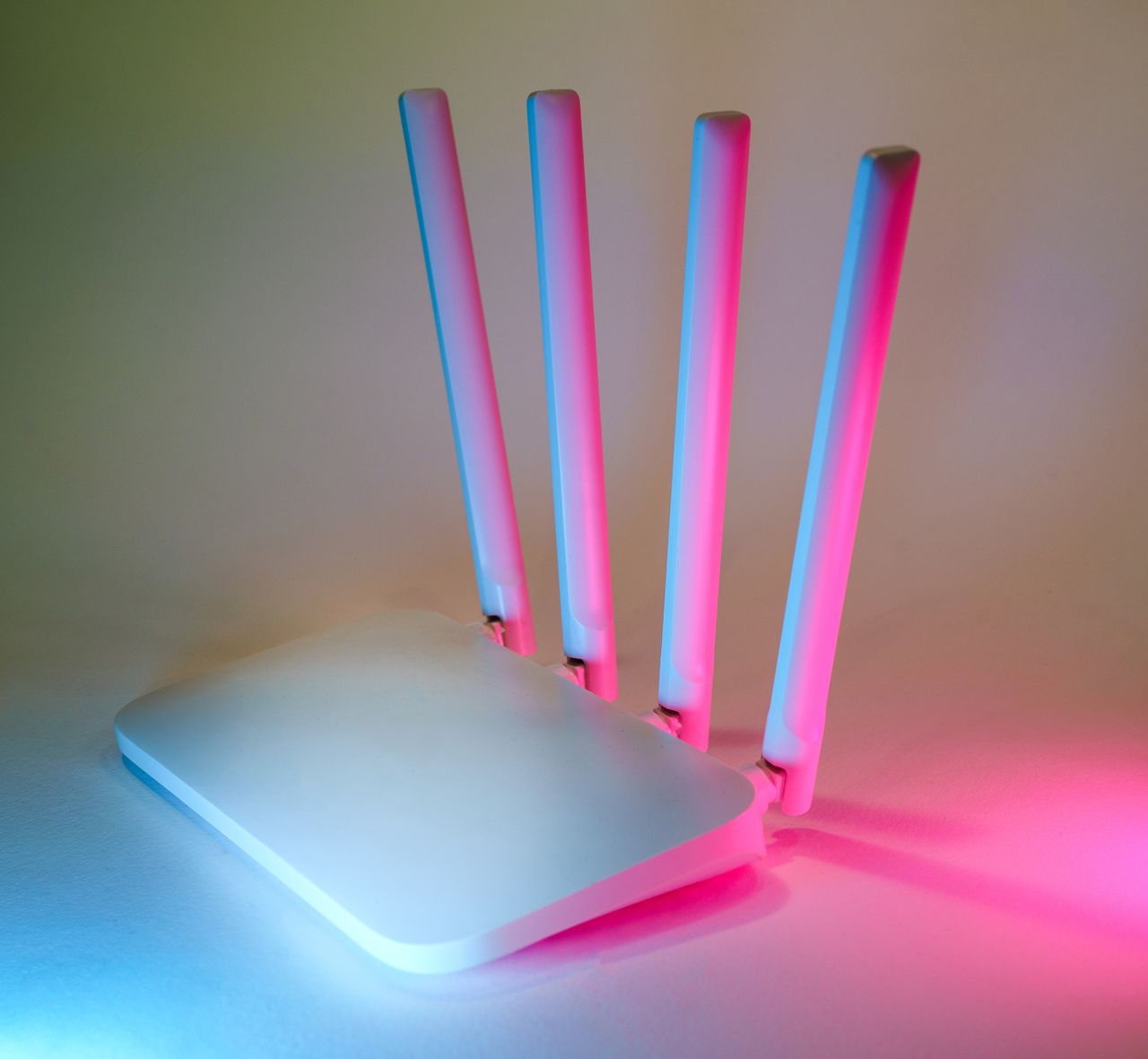 services-01 A sleek wireless router enhanced by vibrant neon lights, showcasing cutting-edge technology.