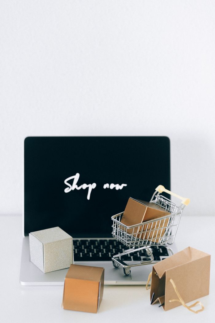 services-03 Minimalist online shopping setup with laptop, cart, and packages symbolizing e-commerce.